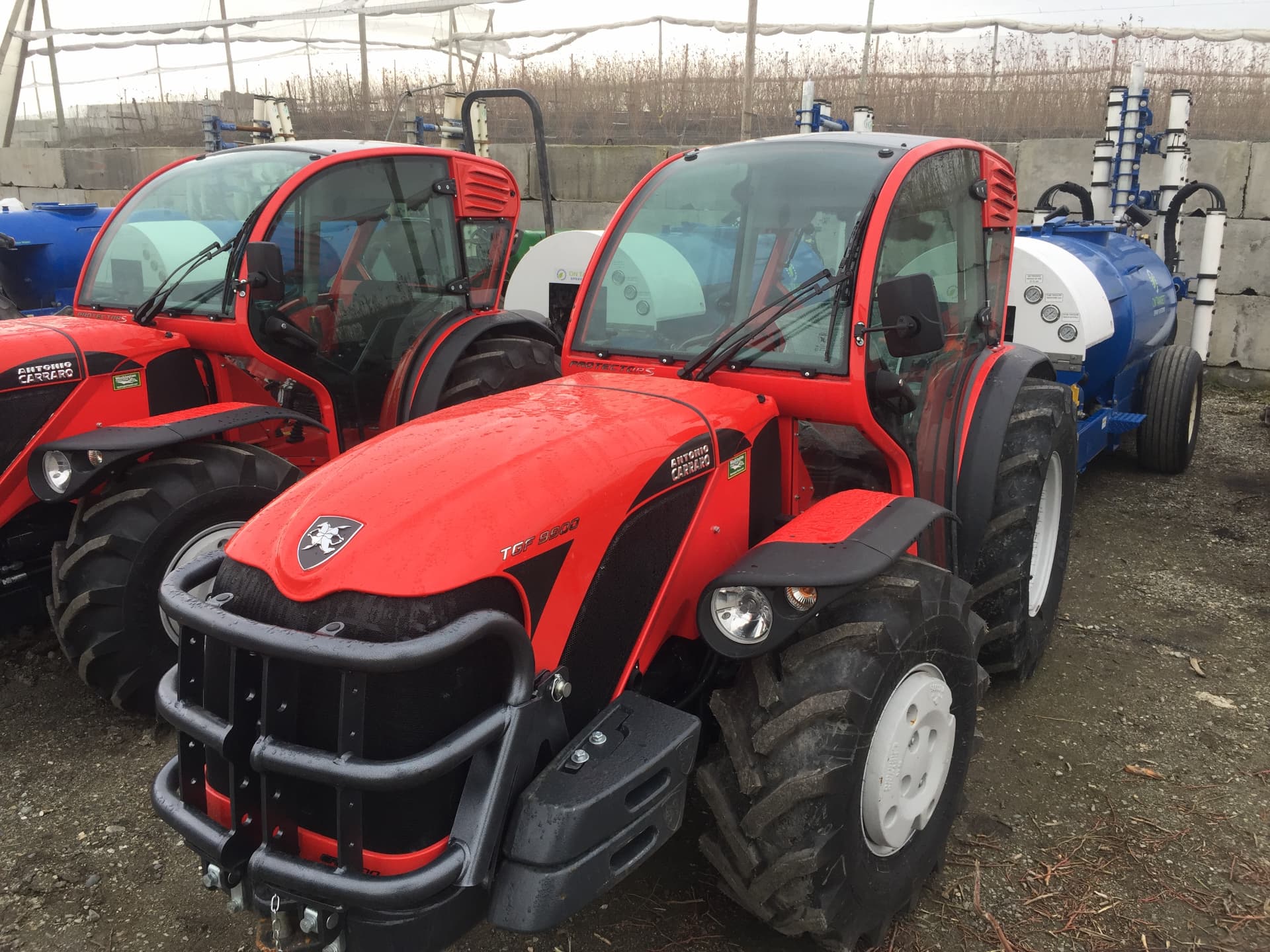 OnTarget orchard sprayers matched to compact tractors in a yard