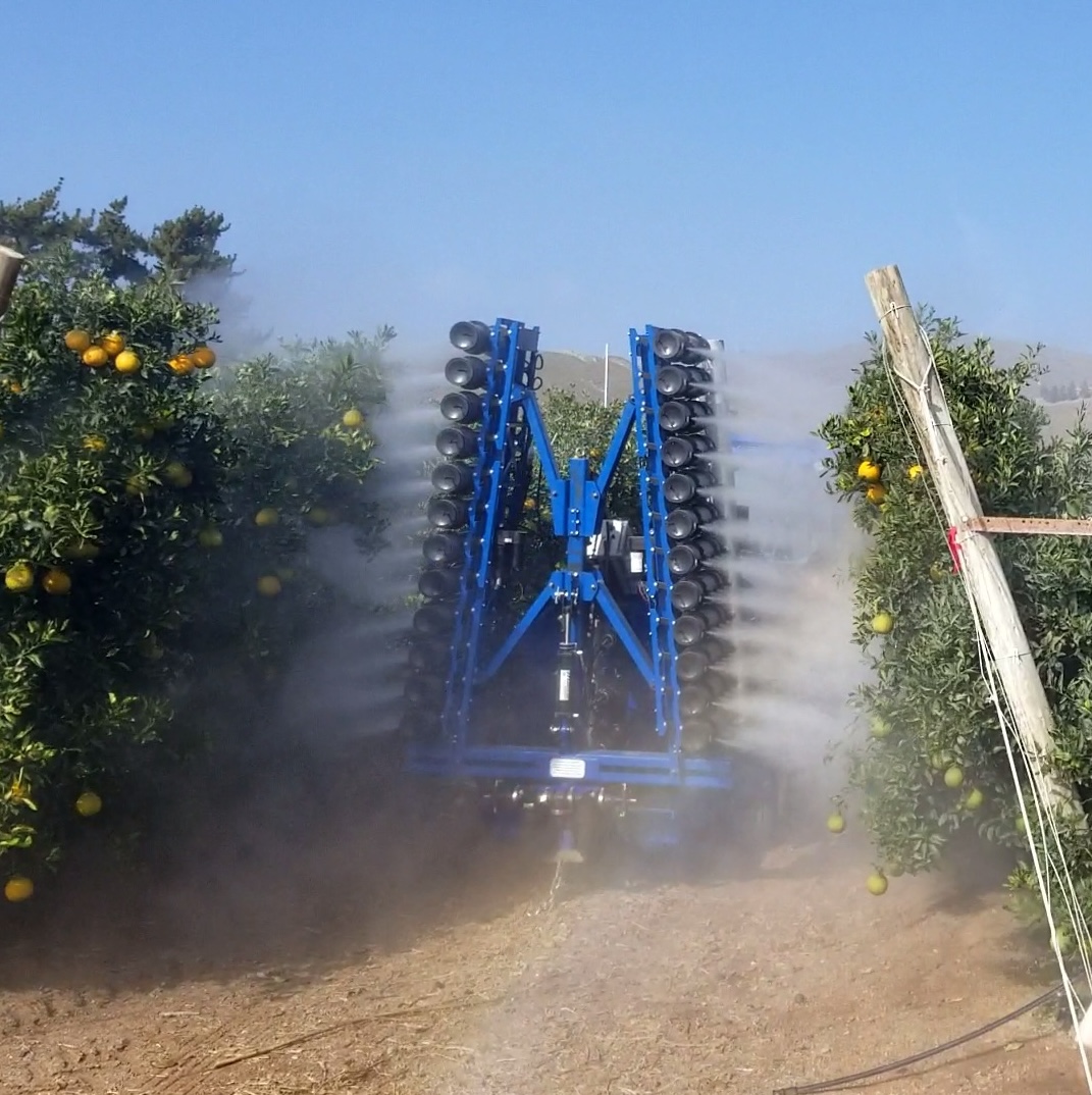 OnTarget electrostatic sprayer running through a citrus orchard